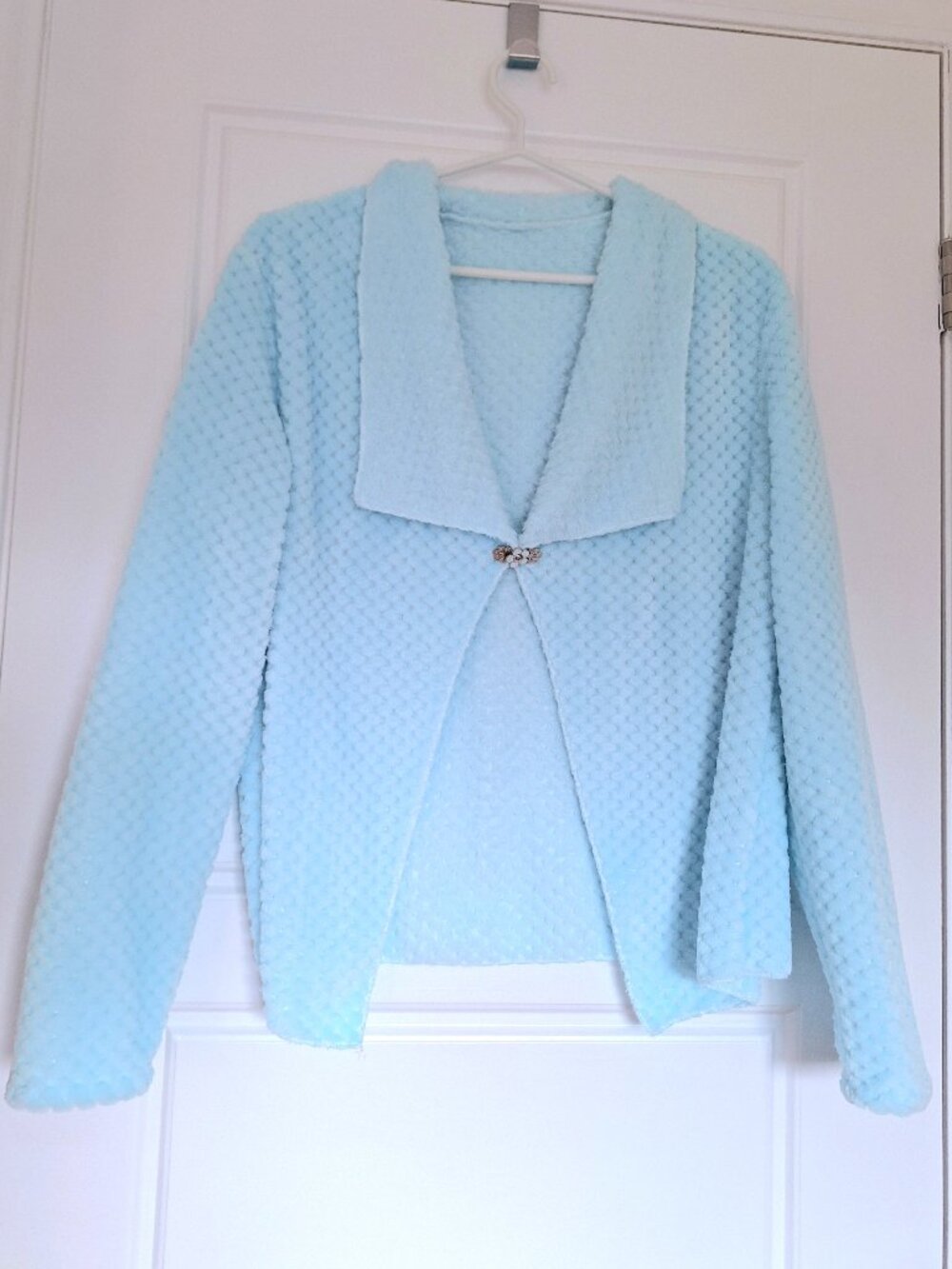 Sky blue waterfall collar jacket with flower pin closure